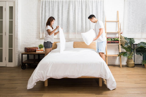 a-couple-make-bed-together